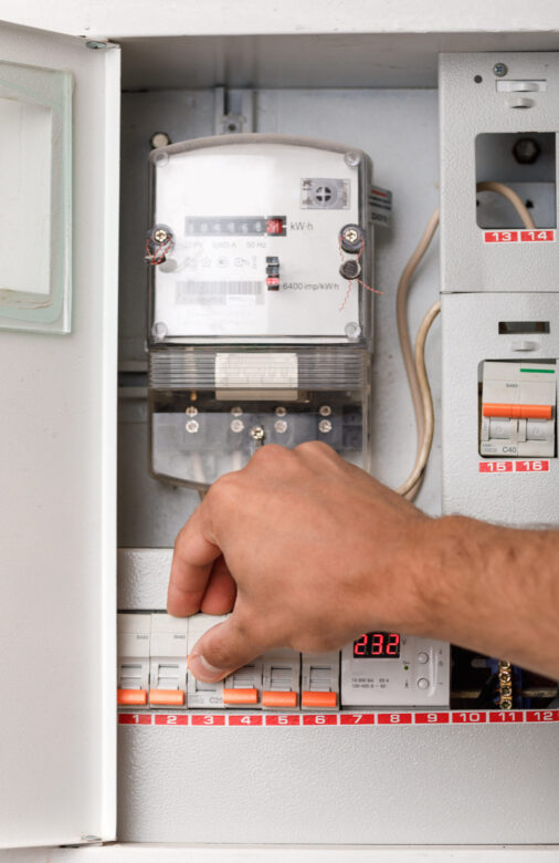 Electrical terminal box. man checking the electric control box. overload relay.