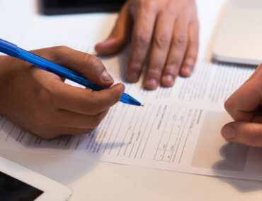 Close-up Of An African Businessperson Signing Contract